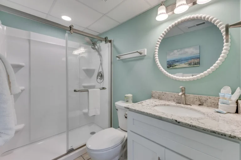 Updated bathroom with walk-in shower inside The Green Starfish condo at Atlantic Towers